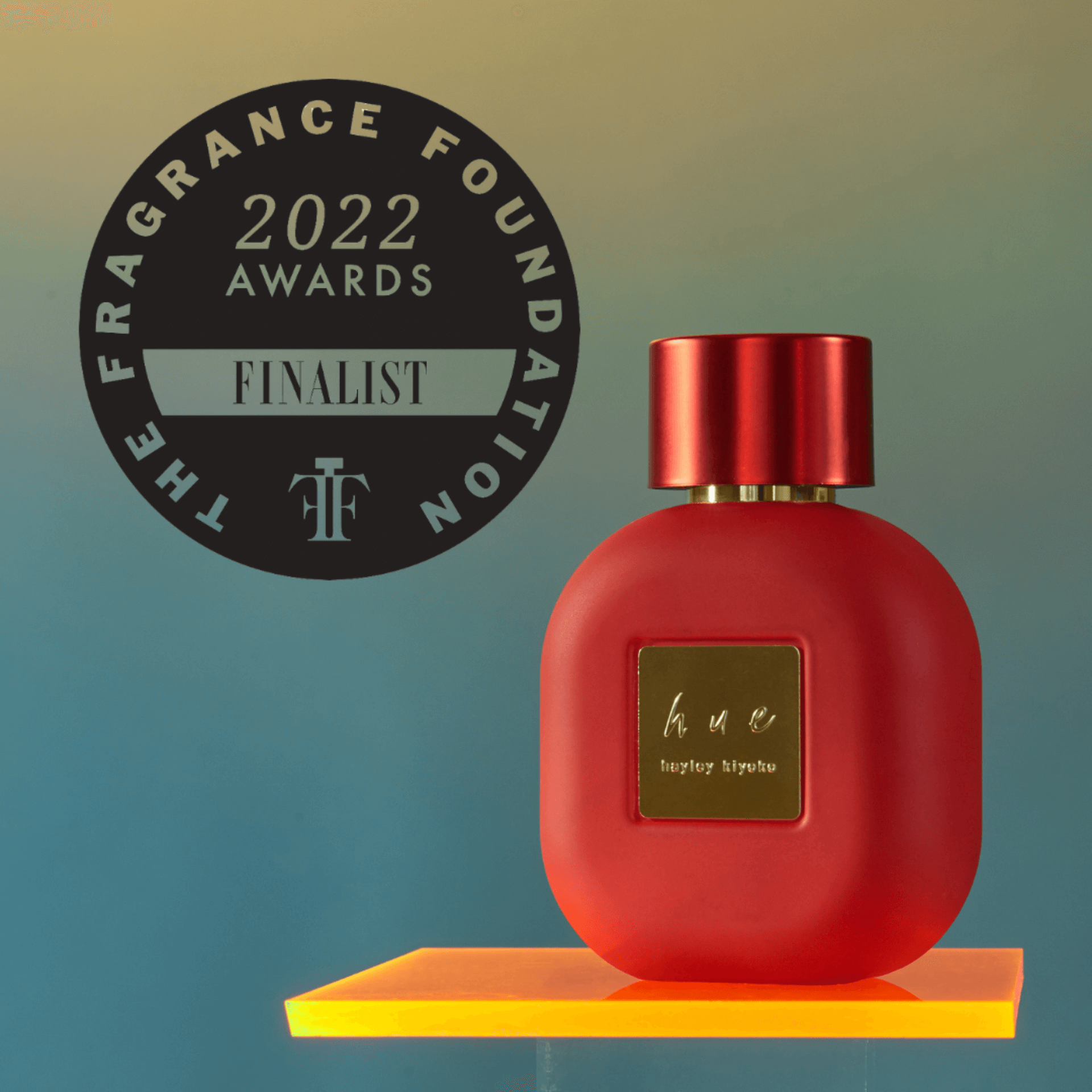 Hue by Hayley perfume, created by pop-star Hayley Kiyoko, displayed on a floating shelf.