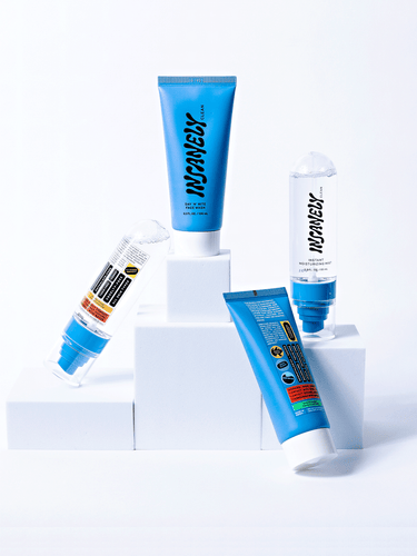 The best mens skincare essentials assembled next to each other on white blocks.