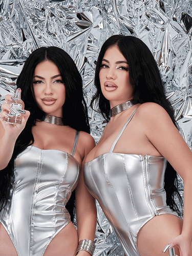 Youtube stars, Brittany and Briana Murillo, posing with the perfume they created called Mirrored Image.